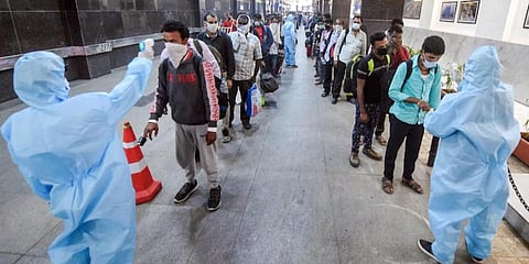 BMC health workers screening passengers for COVID-19 at CST in Mumbai.