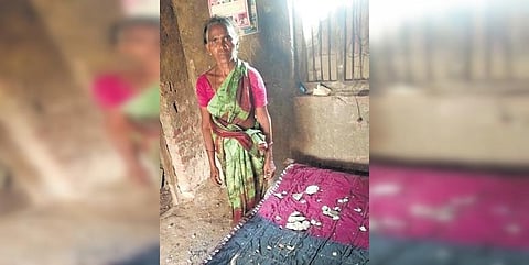 A woman shows the pieces of concrete that fell from the ceiling and walls of her house at Rajerla village. (Photo| EPS)
