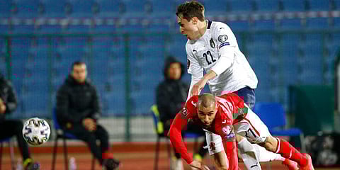 Bulgaria's Momchil Tsvetanov, foreground, challenges Italy 's Federico Chiesa, during the World Cup 2022 group C qualifying match. (Photo | AP)