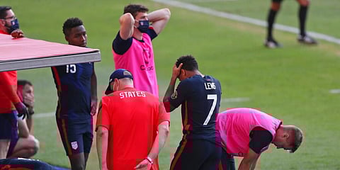 United States' players react at the bench during a Concacaf Men's Olympic qualifying championship semi-final. (Photo | AP)