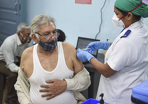 A medic administers the first dose of COVID-19 vaccine to a senior citizen during the second phase of a countrywide inoculation drive at Rajawad Municipal Hospital in Mumbai Wednesday. (Photo | PTI)