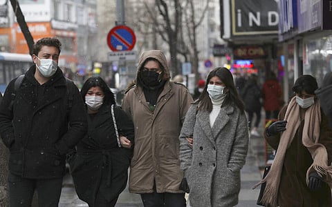 People wearing masks to help protect against the spread of the coronavirus walk in Ankara, Turkey (Photo | AP)