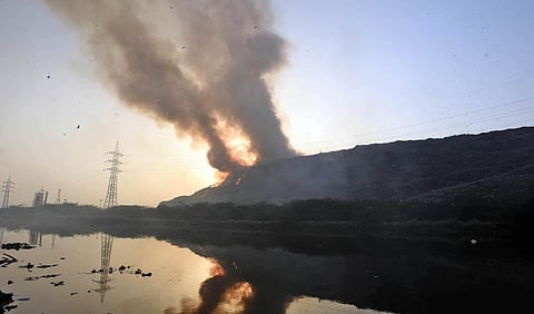A section of the landfill site had caught fire on Sunday evening, worsening pollution levels in the area. (Photo | Parveen Negi, EPS)