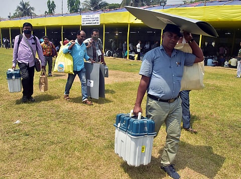 Polling officials carrying EVMs and other polling materials ahead of the second phase of West Bengal Assembly elections, in East Medinipur on Wednesday. (Photo | ANI)