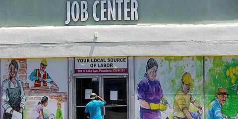 A person looks inside the closed doors of the Pasadena Community Job Center in Pasadena, Calif., during the coronavirus outbreak. (Photo | AP)