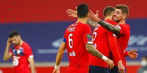 Lille players celebrate after Jonathan David scored his side's second goal during the French League One match against Marseille. (Photo | AP)