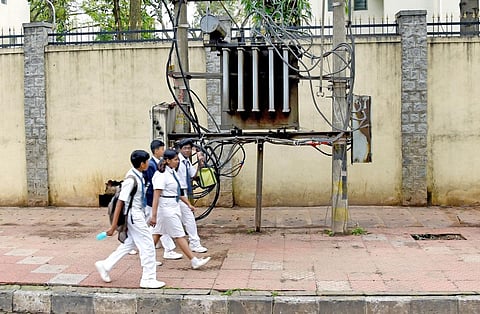 Children walk past a transformer installed without any safety fencing on a footpath on BEL Road | Express