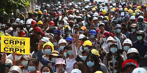 Protesters flash a three-fingered sign of resistance during a demonstration against the Feb. 1 military coup in Mandalay, Myanmar. (Photo | AP)