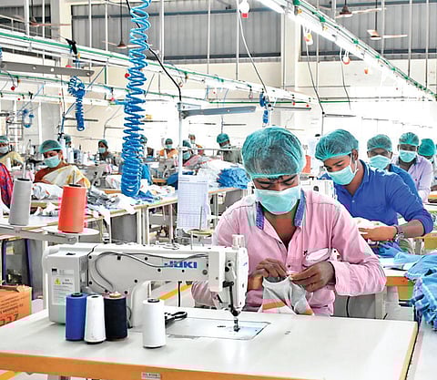 A file picture of workers in a garment manufacturing factory in Tirupur