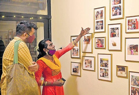 Thara (right) talks to a visitor about the photo exhibit Kathegala Kanive