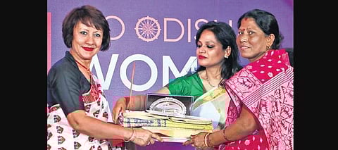 FICCI FLO national president Jahnabi Phookan and FLO Bhubaneswar Chapter chairperson Dharitri Patnaik felicitating community leader Lily Swain | IRFANA