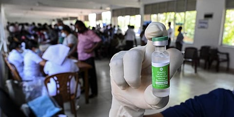A health worker shows a vial of Covid-19 coronavirus vaccine in Colombo, Sri Lanka. (Photo | AFP)