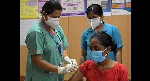 A file picture of a health worker taking the jab in Bengaluru. (Photo | Meghana Sastry, EPS)