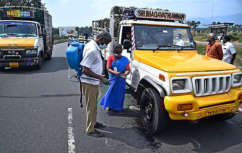 Vehicles entering Tamil Nadu via Walayar check post at outskirts of Coimbatore being disinfected (Photo | A Raja Chidambaram, EPS)