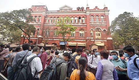 Railways employees stand on the road as they are not allowed to enter the New Koilaghat building Eastern Railway HQ a day after a fire in Kolkata. (Photo | PTI)