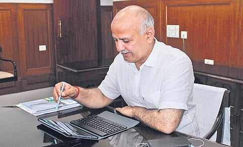 Deputy CM Manish Sisodia reviews the budget on a tablet on Monday | Parveen Negi