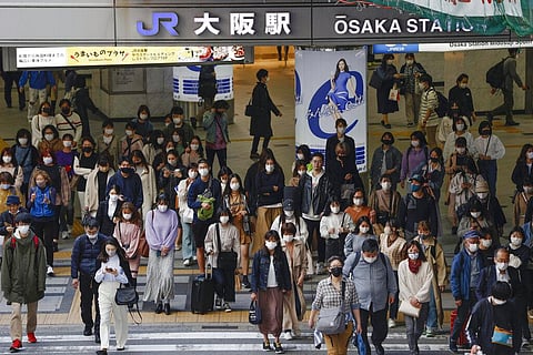 People wear face masks as they make their way in Osaka, western Japan (Photo | AP)
