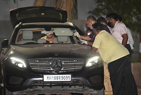 NIA officers investigate Sachin Vaze's Mercedes car, in connection with a probe into the recovery of explosives from a car parked near Mukesh Ambanis house. (File Photo | PTI)