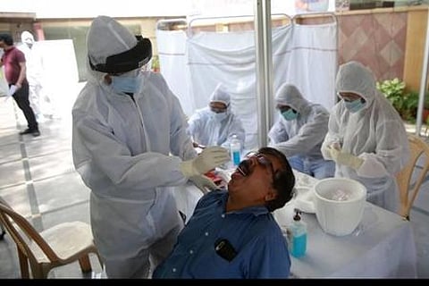 A healthcare worker takes a swab sample for COVID-19 test. (Photo | Express)