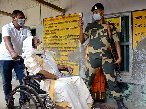 Paramilitary personnel clicks a picture as West Bengal Chief Minister Mamata Banerjee visits a polling booth during the second phase of the assembly election at Boyal in Nandigram. (Photo | ANI)