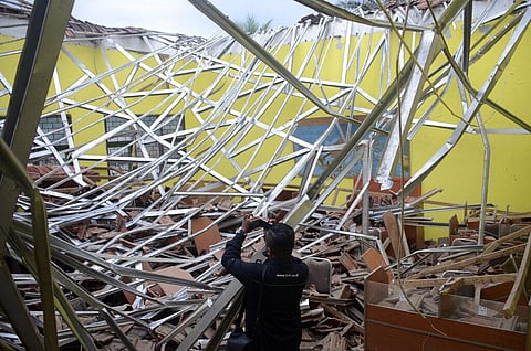 A local journalist films the damage to a class room at a school following an earthquake in Malang, East Java, Indonesia, Saturday, April 10, 2021. (Photo | AP)