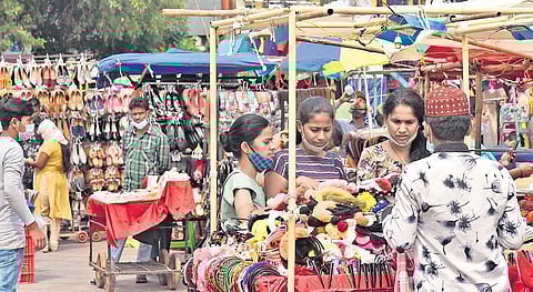 A group of women purchase goods from a bazar without properly wearing their masks, in Hyderabad on Friday | Vinay Madapu