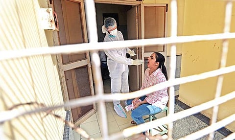 A health workers takes swab sample for Covid testing. (Photo | Shekhar Yadav, EPS)