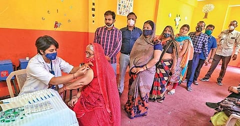 A beneficiary receives a dose of Covid vaccine at a camp in Jaipur on Saturday. (Photo | PTI)
