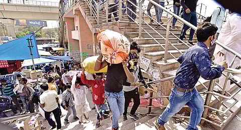 Migrant workers leave for their home states amid surge in Covid-19 cases at Kaushambi bus terminal in Ghaziabad. (Photo | Shekhar Yadav, EPS)