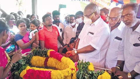 CPM State Secretary K Balakrishnan paying homage to the deceased Dalit youth at their village in Shoghanur near Arakkonam on Sunday | express