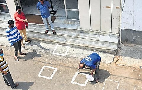 Staffers at Papanna Mutton Stall draw boxes for buyers to maintain social distance outside the shop | Vinod Kumar T