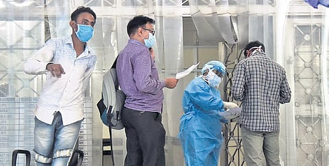 Medical workers in PPE kits attend to people outside the Covid-19 ward at Lok Nayak Jai Prakash Narayan Hospital in New Delhi on Tuesday | Parveen Negi