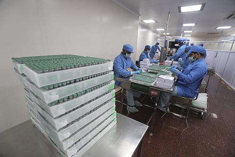 Employees pack boxes containing vials of AstraZeneca's Covishield vaccine at the Serum Institute of India in Pune. (Photo | PTI)