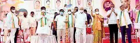 Chief Minister B S Yediyurappa and party candidate Mangala Angadi wave during a campaign