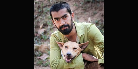 A rescuer pose with a pupper.