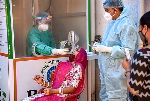 A medic takes swab sample for COVID-19 test at NMMC Hospital, Turbhe village, in Navi Mumbai. (Photo | PTI)