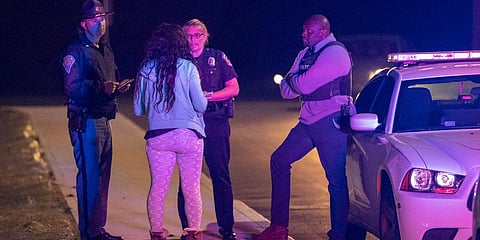 IMPD spokesperson Genae Cook speaks with a person looking for information on the people inside the FedEx building where multiple people were reportedly shot in Indianapolis. (Photo | AP)