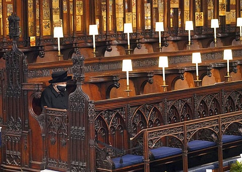 Britain's Queen Elizabeth II sits alone in St. George’s Chapel during the funeral of Prince Philip, at Windsor Castle, Windsor, England, Saturday April 17, 2021. (Photo | AP)