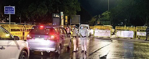 Police personnel check vehicles in Connaught Place as a 55-hour-long lockdown began in New Delhi on Friday night | parveen negi