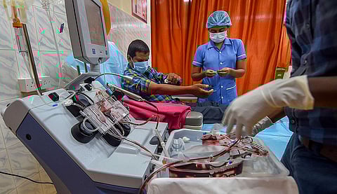 A COVID-19 survivor donates plasma at a Plasma Bank. (Photo | PTI)