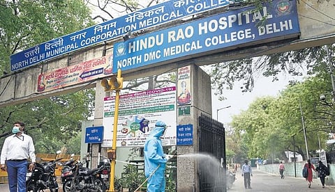 Health workers spray disinfectants at the Hindu Rao Hospital in New Delhi. (Photo | Parveen Negi, EPS)