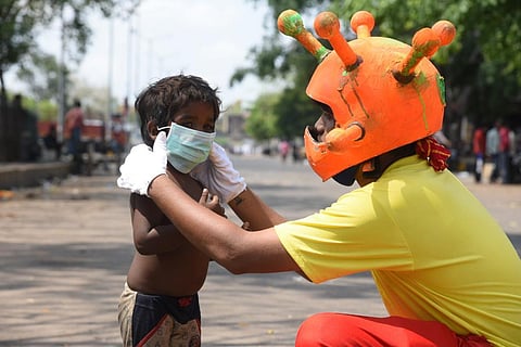 Volunteers spreading awareness about COVID-19 measures at Koyambedu market, in Chennai on Sunday. (Photo | R Satish Babu, EPS)