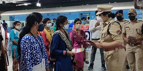 RPF cops counselling women passengers on safety measures and getting their feedback on improvements needed at KSR railway station in Bengaluru. (Photo | Express)