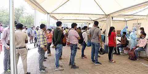 Passengers stand in a queue to get tested for COVID-19 at Anand Vihar Terminal in Delhi. (Photo| ANI)