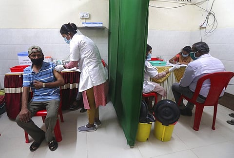 A health worker administers the COVISHIELD vaccine for COVID-19 at a vaccination centre in Dharavi, Mumbai. (Photo |AP)