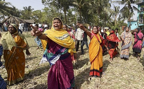 Villagers raise slogans against West Bengal Chief Minister Mamata Banerjee, waiting inside a polling station, during the second phase of West Bengal assembly polls. (Photo | PTI)