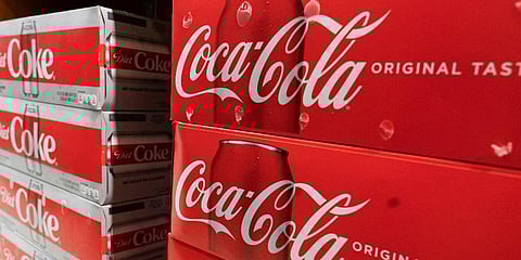 Cases of Coca-Cola are displayed in a supermarket, in New York. (Photo| AP)
