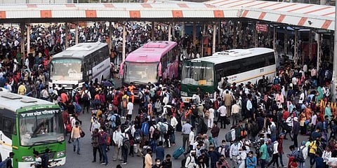 Large numbers of migrants at Kaushambi bus stand to board buses for their native place , after lockdown announcement in New Delhi. (Photo | Parveen Negi, EPS)