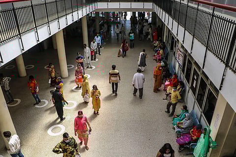 People wearing face masks wait for a medical check-up at a Government hospital in Jammu on Monday. (Photo | PTI)