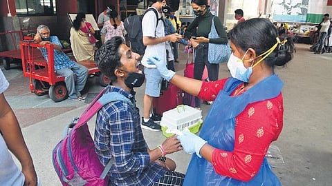 A health worker takes a swab sample from a man in Bengaluru on Monday | EXPRESSÂ
